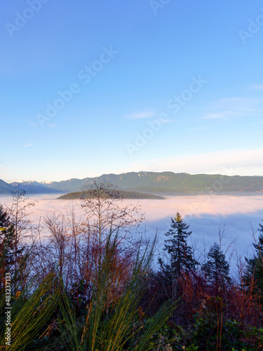 Dense winter cloud inversion partially covering mountains as seen from a BC park.