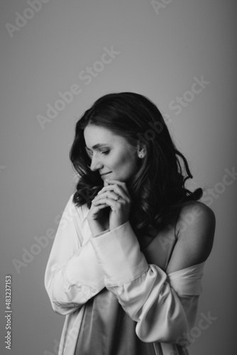young white Ukrainian engaged woman portrait in a studio looking away from the camera in black and white