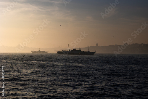 Istanbul background photo. Ferry and cityscape of Istanbul at foggy weather © senerdagasan