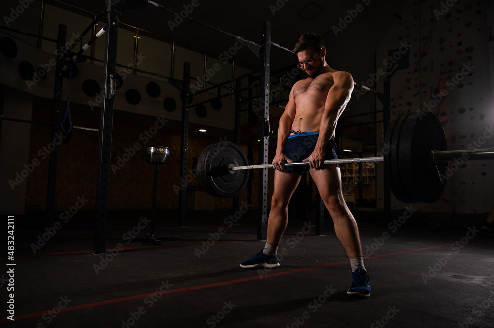 Fototapeta premium Shirtless caucasian man doing deadlift in the gym. 