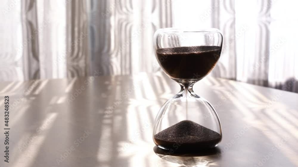 Hourglass on a wooden table. Hourglass on a wooden table.