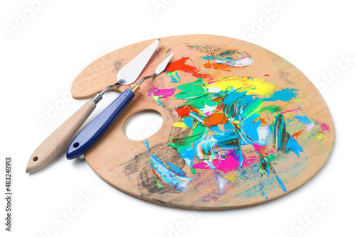 Palette with paints and spatulas on white background. Artist equipment