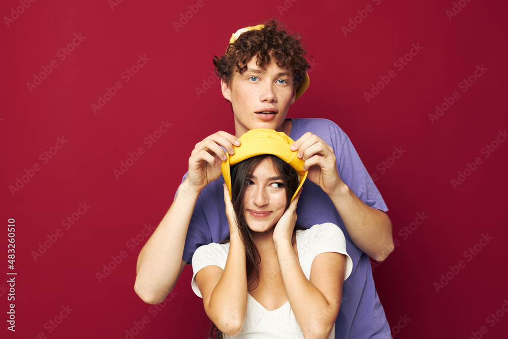 a young couple in colorful t-shirts stylish clothes hats Youth style a young couple in colorful t-shirts stylish clothes hats Youth style
