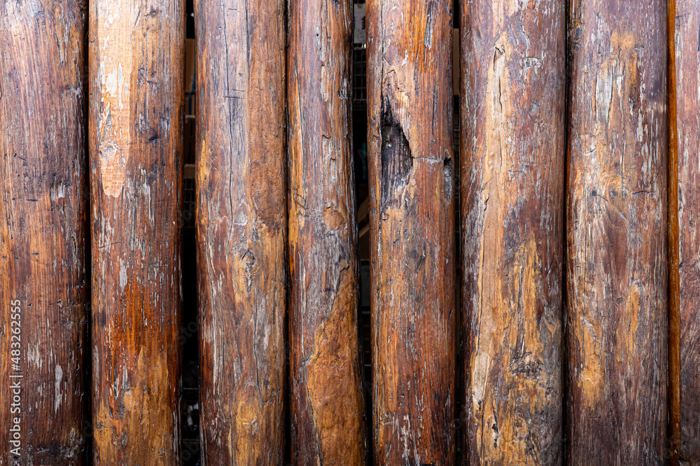 Backdrop of big brown tree logs sorting in vertical. Backdrop of big brown tree logs sorting in vertical.