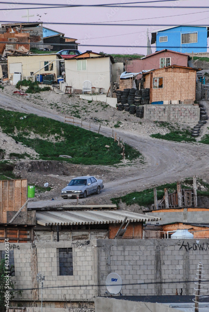 Car Driving Downhill From A Small Dirt Road In Tijuana Car Driving Downhill From A Small Dirt Road In Tijuana