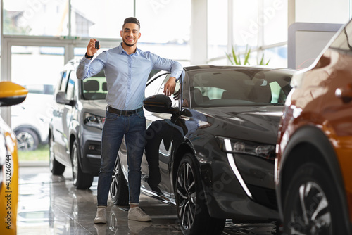 Successful middle-eastern businessman buying new sports car, full size shot © Prostock-studio