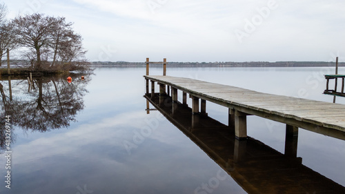Fototapeta Naklejka Na Ścianę i Meble -  landscape Leon french lake in Landes south west France with empty pontoon boat