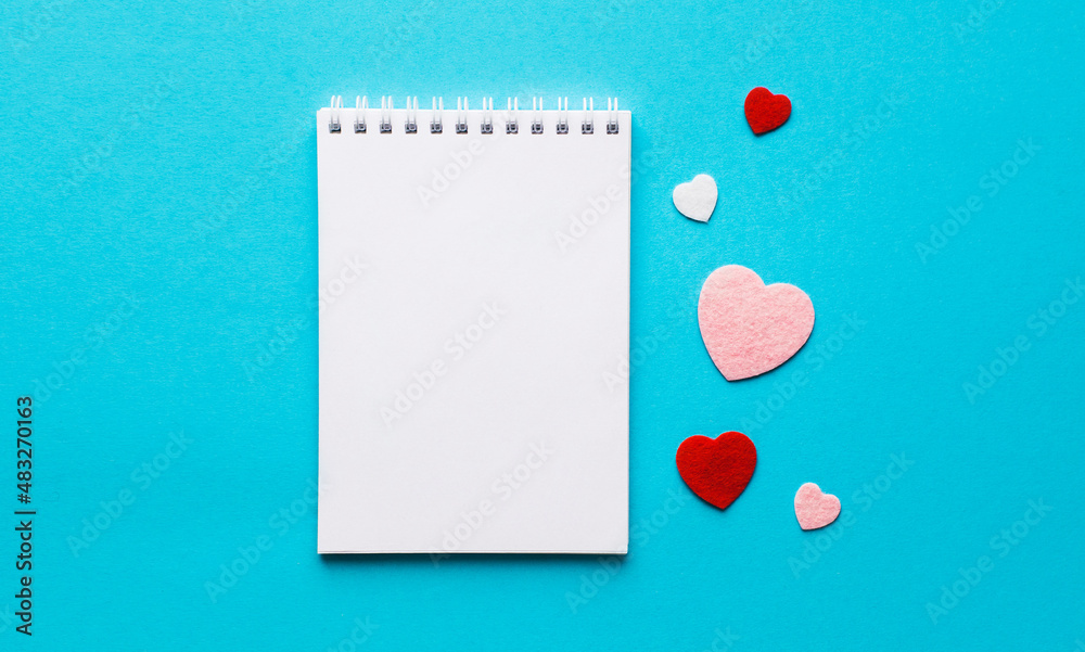 Valentine's day composition with notebook list and hearts on blue background. Wedding, birthday, woman's and mother day concept. Flat lay, top view, copy space, place for text, empty, mock up, banner Valentine's day composition with notebook list and hearts on blue background. Wedding, birthday, woman's and mother day concept. Flat lay, top view, copy space, place for text, empty, mock up, banner