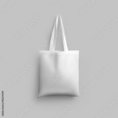 White cotton totebag mockup, isolated, hanging on wall background, 3d rendering.
