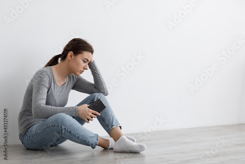 Sad despair european millennial woman suffering from depression, worried and anxious alone photo