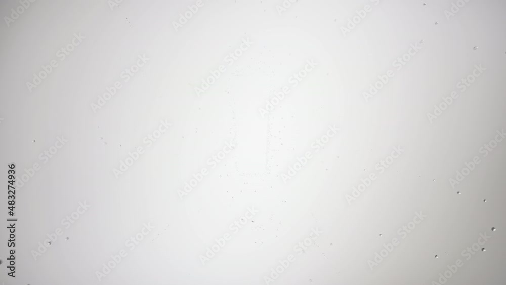 Exclamation sign printed on the wet glass blown off with air stream on grey background | warning concept Exclamation sign printed on the wet glass blown off with air stream on grey background | warning concept