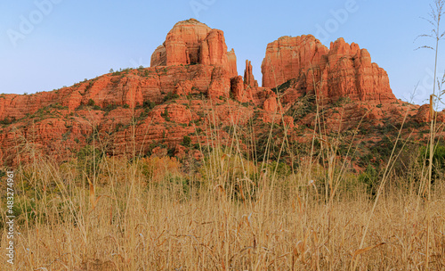 The red rock formations reaching for the sky as the sun warms the stone and highlights the autumn leaves is a typical scenic landscape in the spiritual, beautiful Sedona, Arizona in western USA