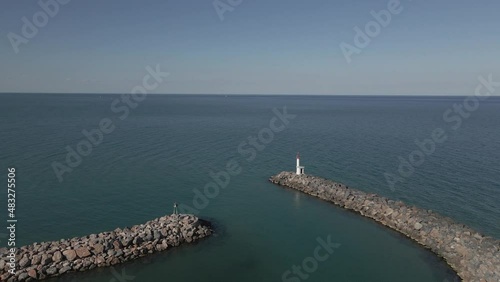 Stone rip rap breakwater protects harbour from calm Mediterranean Sea photo