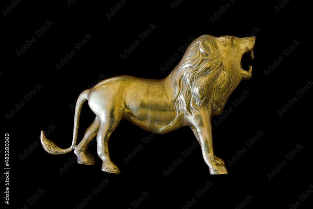 Fototapeta premium Statue of the lion isolated on a black background.