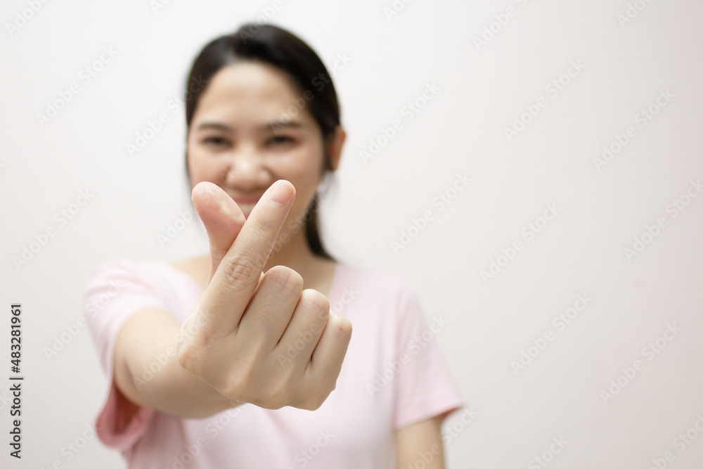 Asian beautiful woman make mini heart gesturing and express happiness and smiling for valentine's day. Love concept. Close up heart hand shape gesture. Asian beautiful woman make mini heart gesturing and express happiness and smiling for valentine's day. Love concept. Close up heart hand shape gesture.