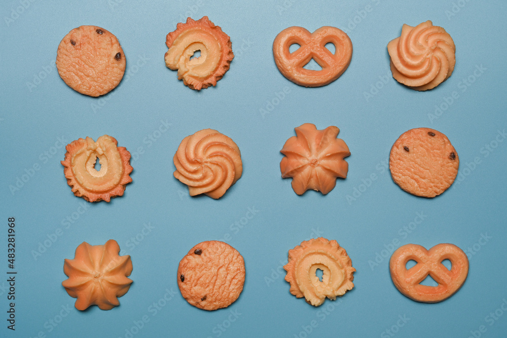 Tasty variety danish butter cookies on blue background.