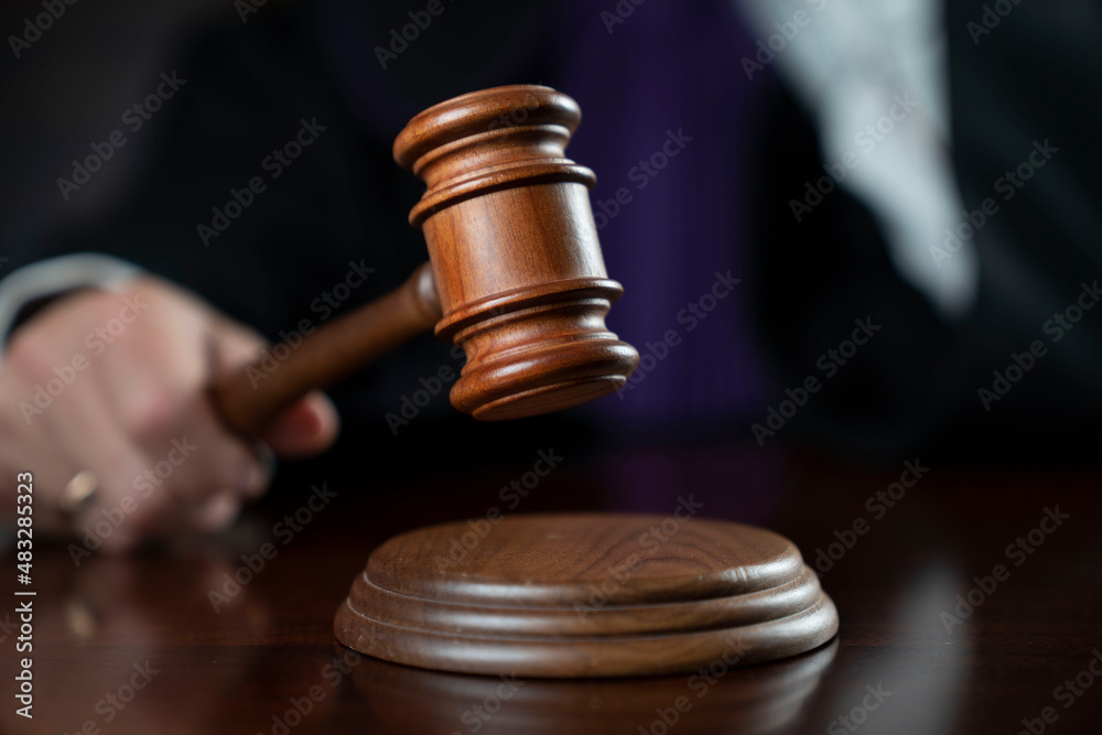Courtroom. Judge with the wooden gavel in his hand. Law and justice theme. Courtroom. Judge with the wooden gavel in his hand. Law and justice theme.