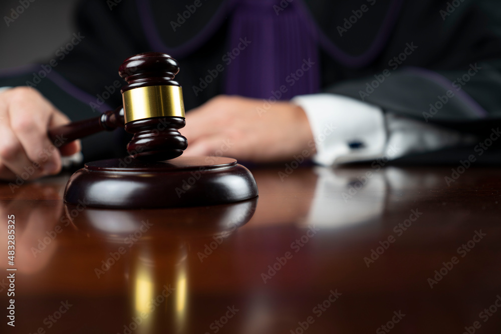 Courtroom. Judge with the wooden gavel in his hand. Law and justice theme. Courtroom. Judge with the wooden gavel in his hand. Law and justice theme.