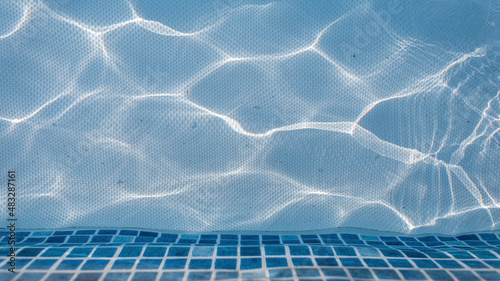 Swimming pool with blue water, top view. Water texture