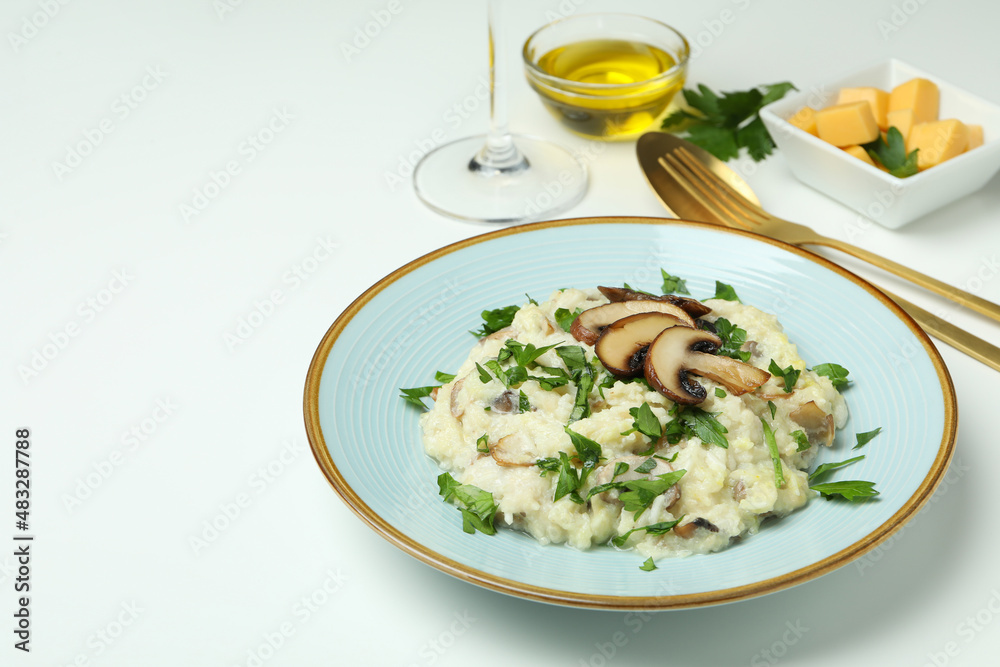 Concept of tasty food with risotto with mushrooms on white background Concept of tasty food with risotto with mushrooms on white background