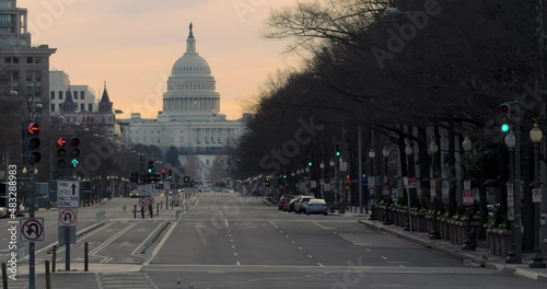 Line Of Traffic Signals Changing From Green To Red In Front Of U.S. Capitol In Washington, D.C. With Bold Orange Sky photo