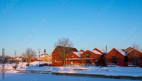 A chirch and old, red, wooden houses at old center of Oulu, Finland
