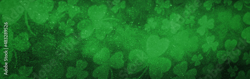 Magical green background with shamrock leaves