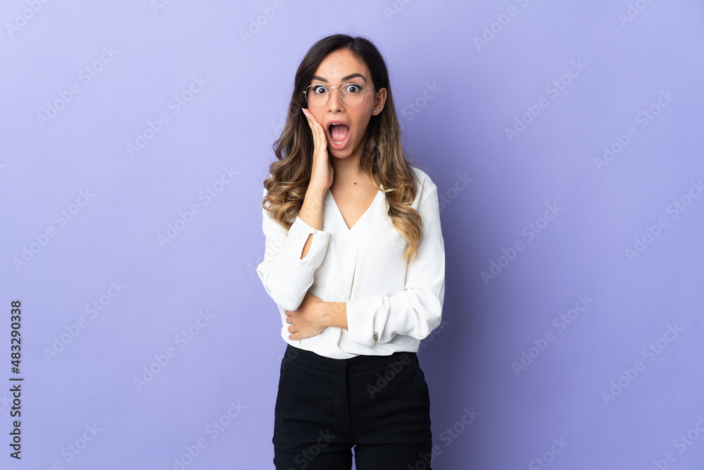 Young caucasian woman isolated on purple background with surprise and shocked facial expression Young caucasian woman isolated on purple background with surprise and shocked facial expression