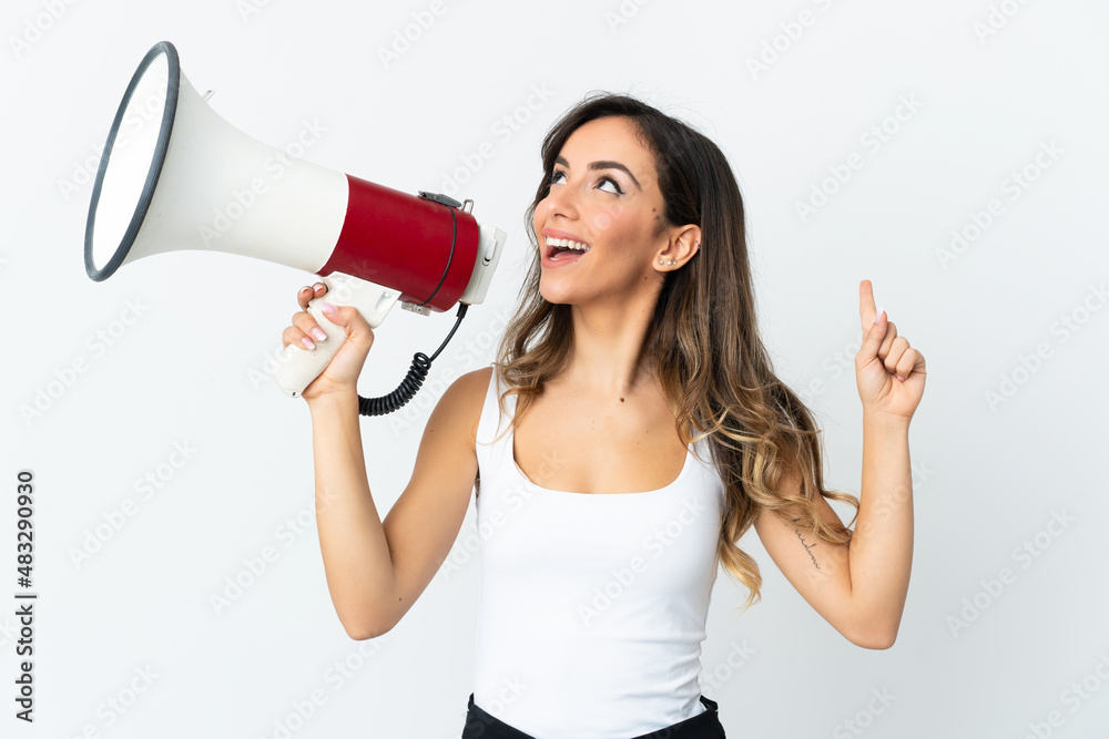 Young caucasian woman isolated on white background shouting through a megaphone to announce something in lateral position Young caucasian woman isolated on white background shouting through a megaphone to announce something in lateral position