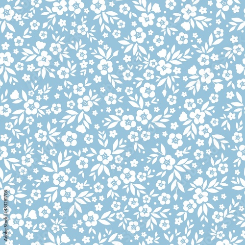 Beautiful vintage pattern. White flowers and leaves . Light blue background. Floral seamless background. An elegant template for fashionable prints.