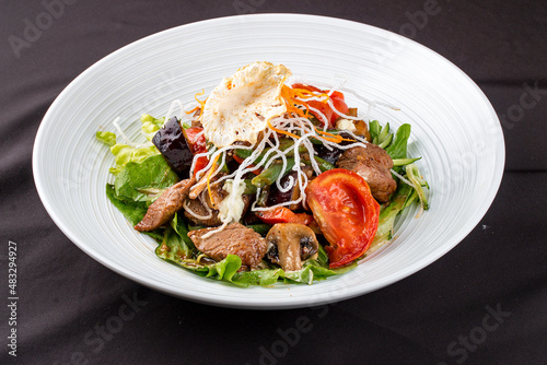 Salad with beef and fresh vegetables with mushrooms.