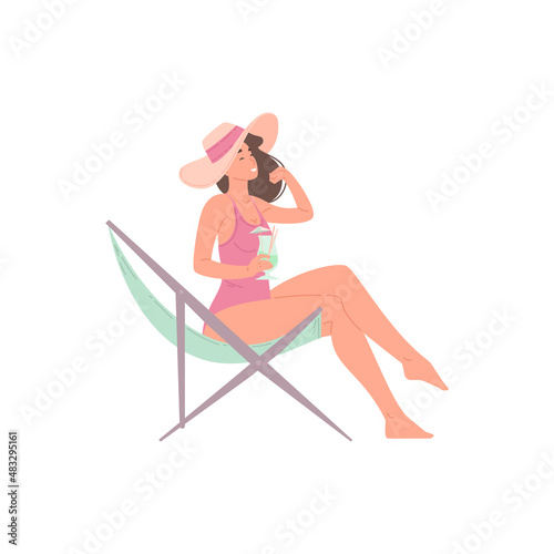 Happy relaxed woman sunbathing on chaise longue with summer cocktail enjoying sea beach vacation
