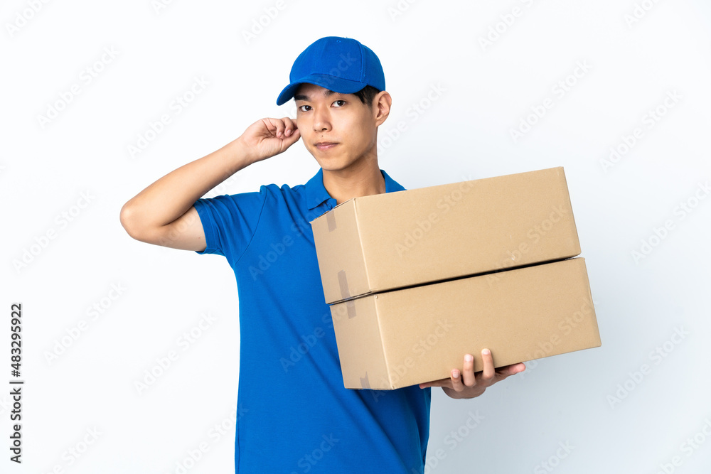 Delivery Chinese man isolated on white background having doubts Delivery Chinese man isolated on white background having doubts