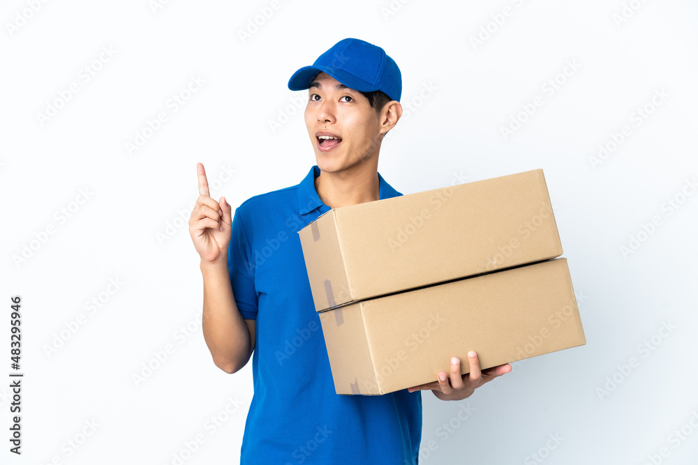 Delivery Chinese man isolated on white background pointing up and surprised Delivery Chinese man isolated on white background pointing up and surprised