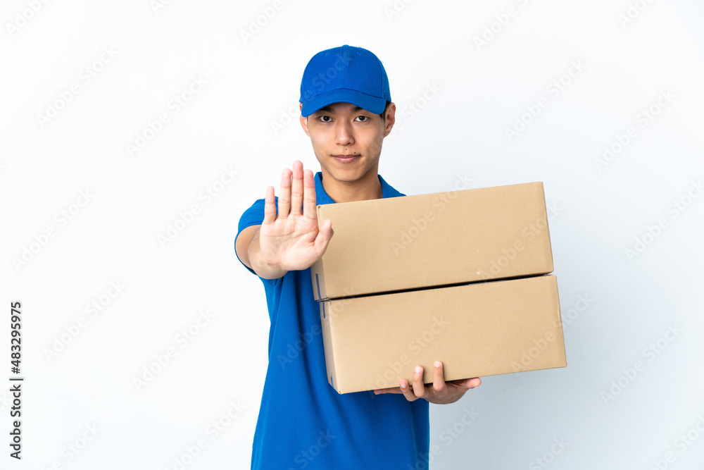Delivery Chinese man isolated on white background making stop gesture Delivery Chinese man isolated on white background making stop gesture