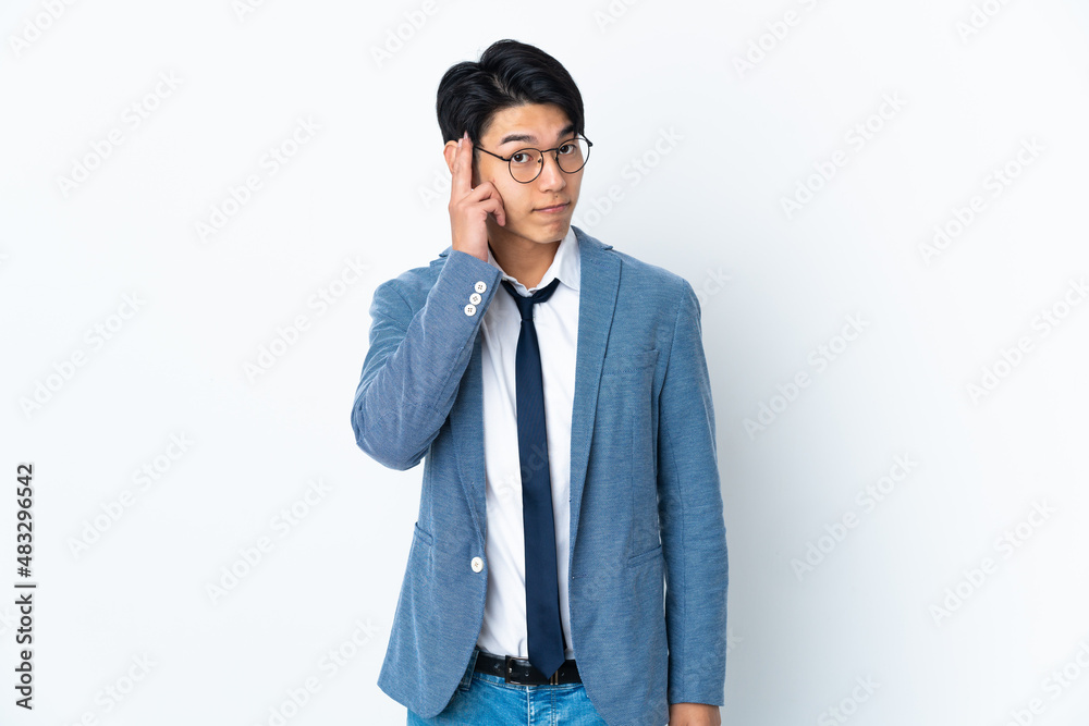 Young Chinese business man isolated on white background thinking an idea Young Chinese business man isolated on white background thinking an idea