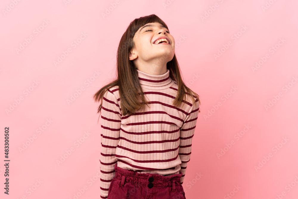 Little girl isolated on pink background laughing