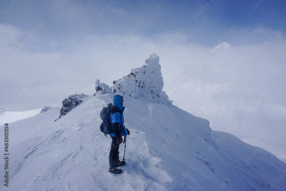 Hiker at the Avachinsky Pass and volcanoes in Kamchatka Hiker at the Avachinsky Pass and volcanoes in Kamchatka