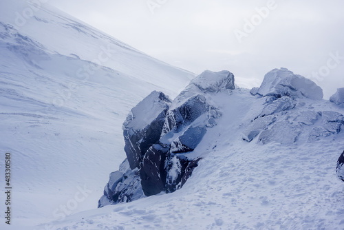 Frozen rocks on the ridge of Avachinsky volcano in winter