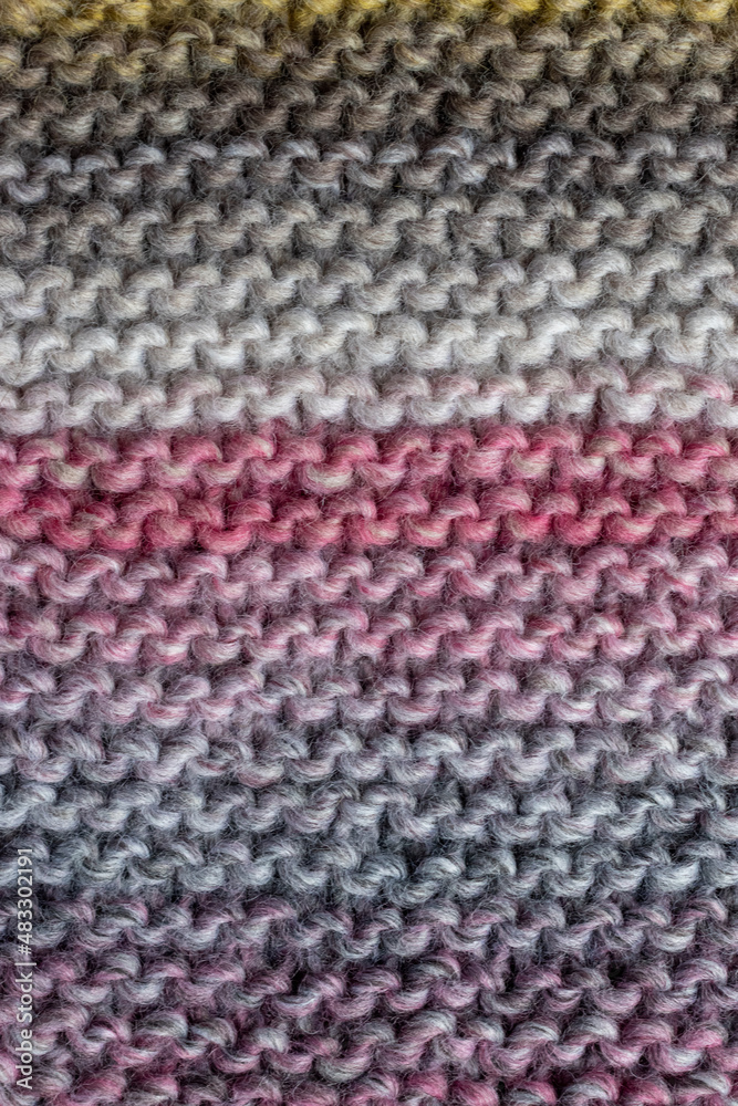 knitting backdrop of hand knit wool fabric in colours of grey and pink knitting backdrop of hand knit wool fabric in colours of grey and pink