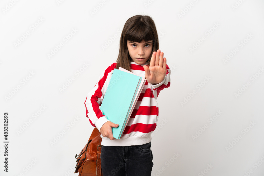 Little student girl isolated on white background making stop gesture Little student girl isolated on white background making stop gesture