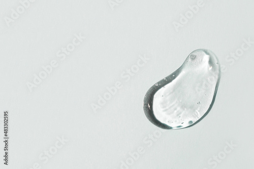 Transparent hyaluronic acid gel on a gray background. photo