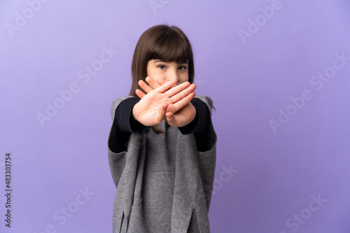 Little girl over isolated background making stop gesture with her hand to stop an act