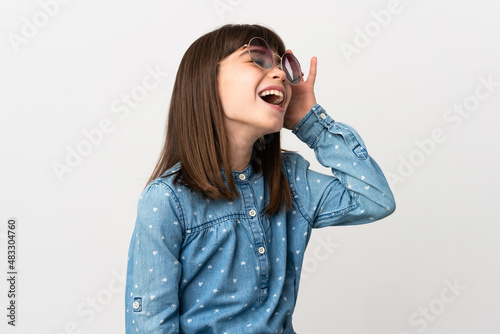 Little girl with sunglasses isolated on white background smiling a lot