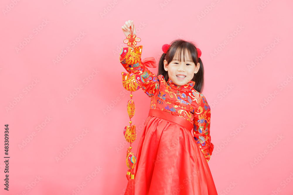 Chinese girl with traditional dressing up and holding a Chinese girl with traditional dressing up and holding a