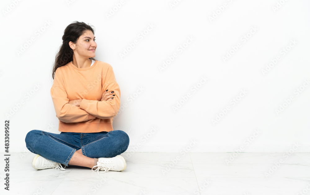 Teenager Russian girl sitting on the floor in lateral position Teenager Russian girl sitting on the floor in lateral position
