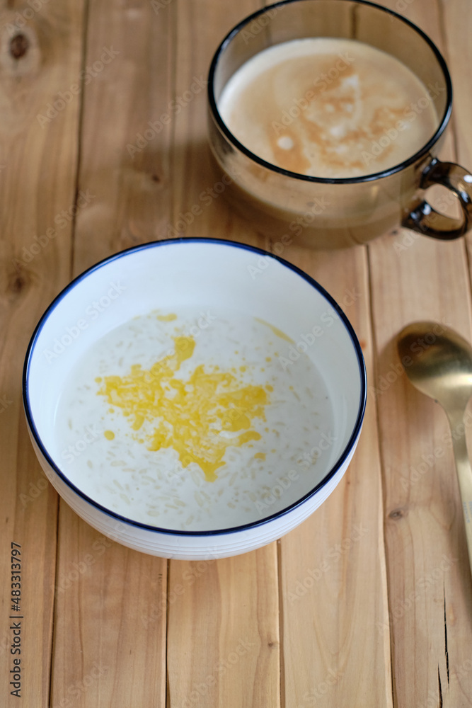 Rice milk porridge. Side view, wooden background. Rice milk porridge. Side view, wooden background.