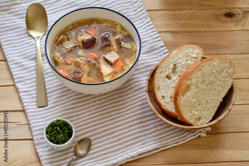 Mushroom soup with noodles. Side view, wooden background