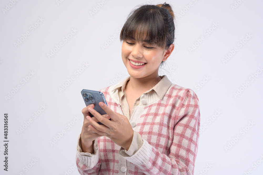 Young beautiful woman using smart phone isolated on white background Young beautiful woman using smart phone isolated on white background