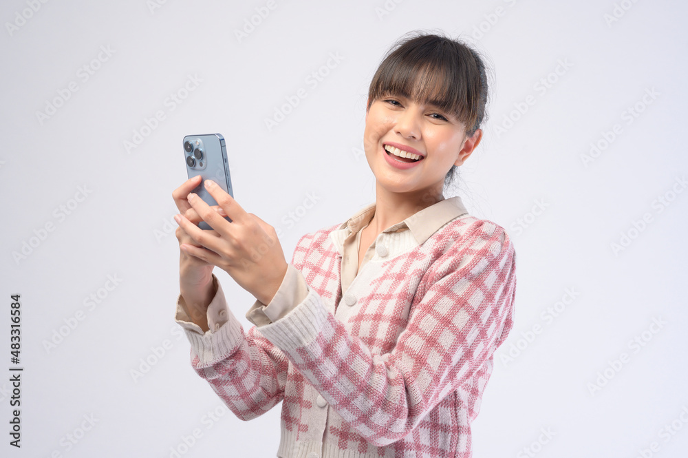Young beautiful woman using smart phone isolated on white background Young beautiful woman using smart phone isolated on white background